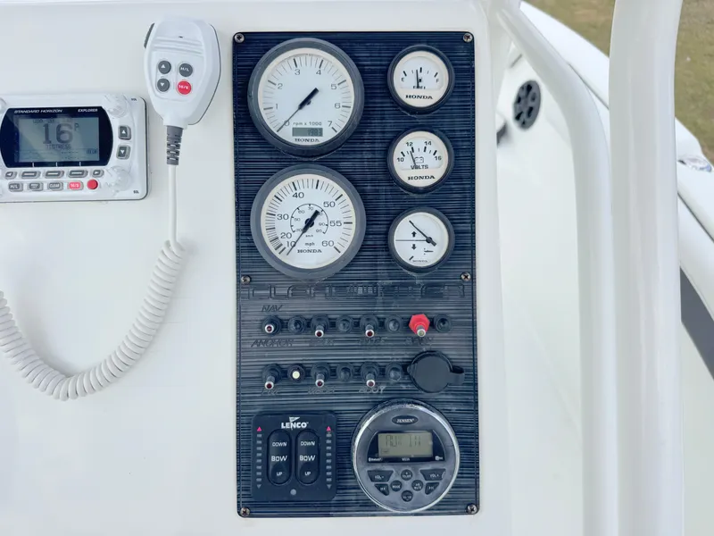 Slide: The Image of Control panel of 2016 Clearwater 2200 WI Center Console boat with gauges and radio. - 19