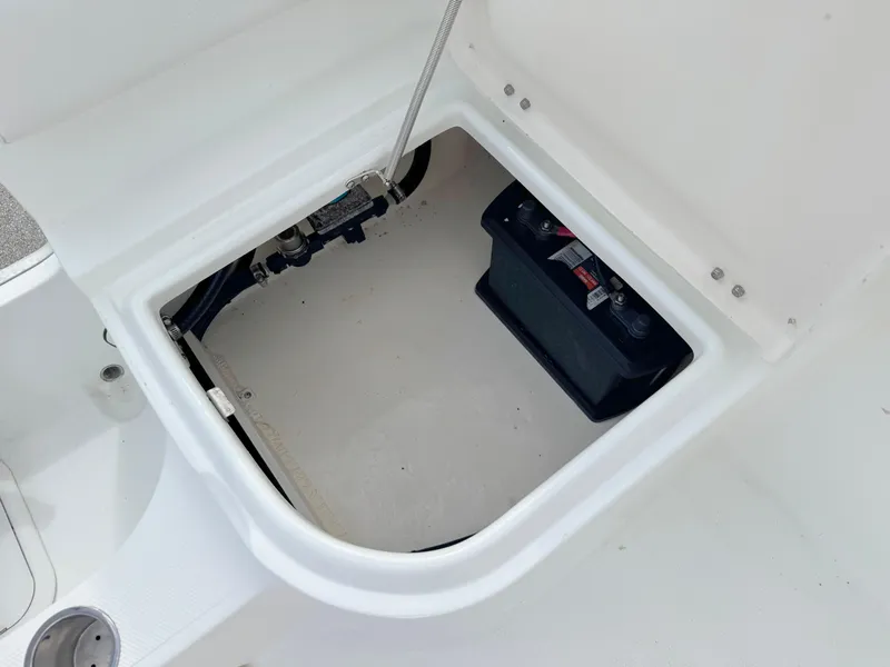 Slide: The Image of Open storage compartment in 2016 Clearwater 2200 WI Center Console boat. - 24