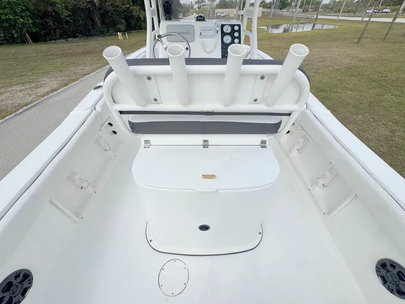 Slide: The Image of 2016 Clearwater 2200 WI Center Console boat interior with rod holders and storage. - 25