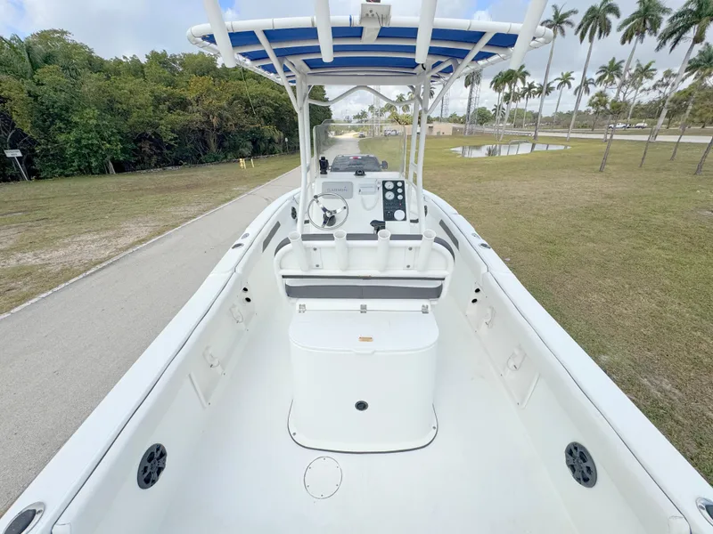 Slide: The Image of 2016 Clearwater 2200 WI Center Console boat on a grassy area with palm trees. - 29