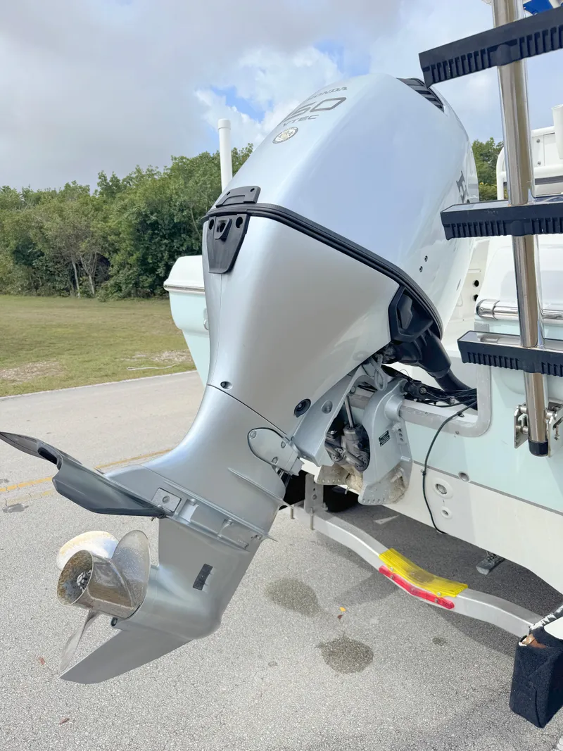 Slide: The Image of 2016 Clearwater 2200 WI Center Console boat with outboard motor, parked outdoors. - 31