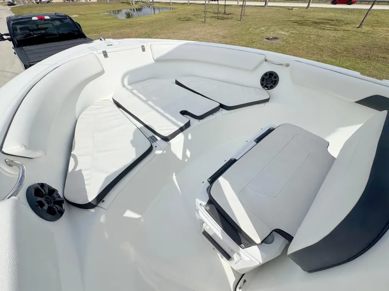 Slide: The Image of 2016 Clearwater 2200 WI Center Console boat interior with cushioned seating and speakers. - 7