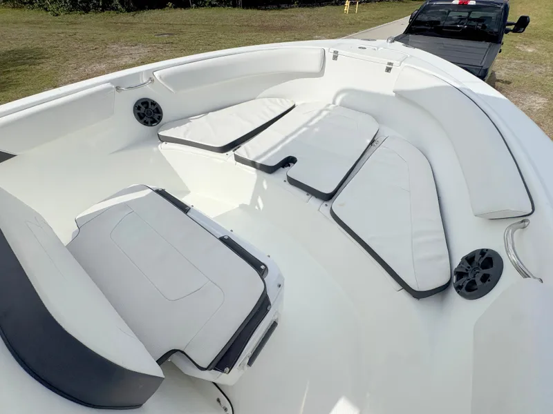 Slide: The Image of 2016 Clearwater 2200 WI Center Console boat interior with cushioned seating and speakers. - 8