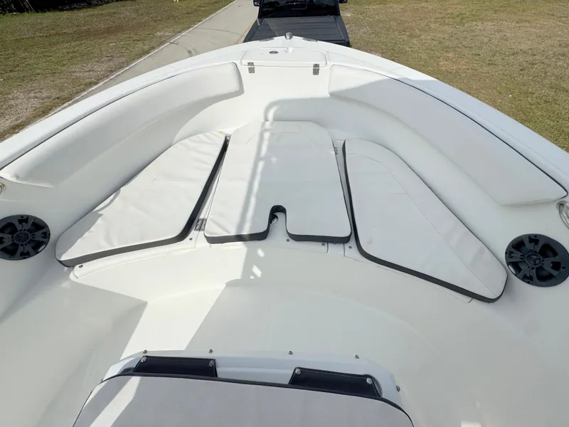 Slide: The Image of 2016 Clearwater 2200 WI Center Console boat interior with cushioned seating and speakers. - 9