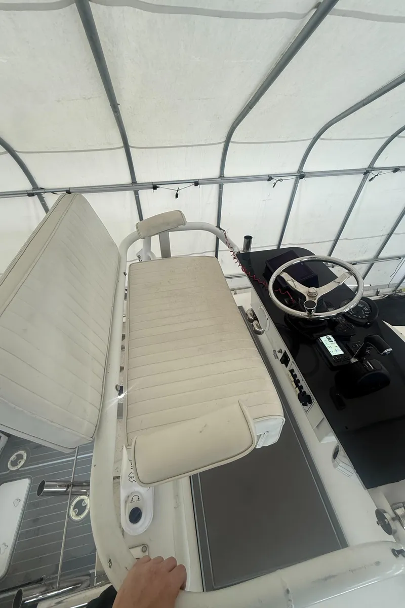 Slide: The Image of 1990 Albemarle 247 Express boat interior with steering wheel and seating. - 10
