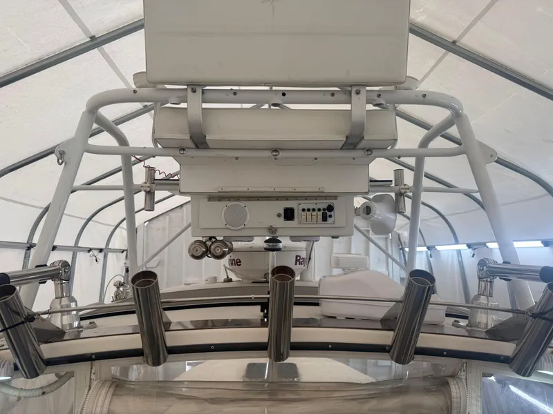 Slide: The Image of 1990 Albemarle 247 Express boat interior with fishing rod holders and electronic equipment. - 11