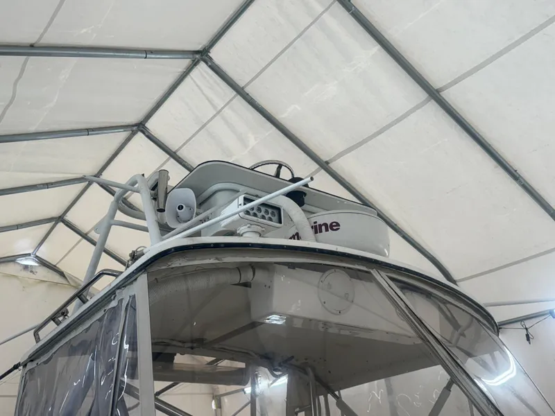 Slide: The Image of 1990 Albemarle 247 Express boat under a protective canopy, showcasing radar equipment. - 13