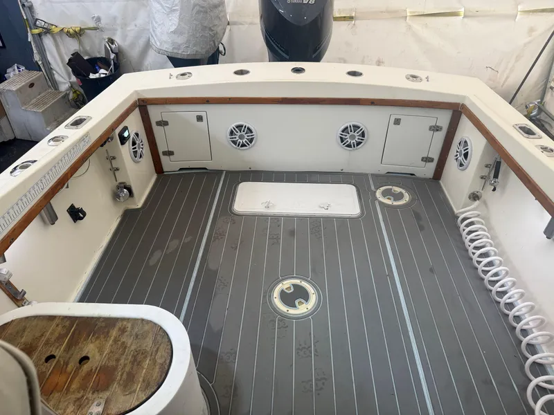 Slide: The Image of 1990 Albemarle 247 Express boat deck with storage compartments and marine speakers. - 14
