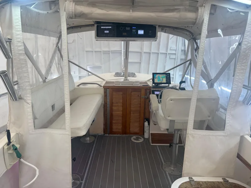 Slide: The Image of 1990 Albemarle 247 Express boat interior with helm, seating, and navigation equipment. - 15