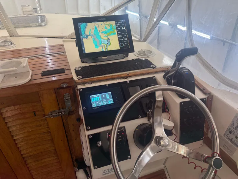 Slide: The Image of 1990 Albemarle 247 Express boat helm with navigation equipment and steering wheel. - 17