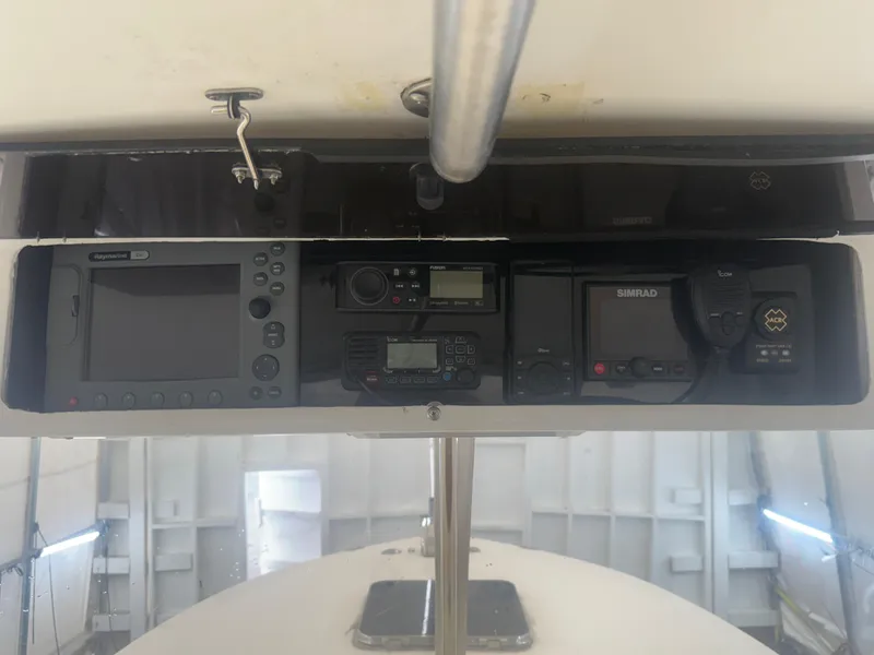 Slide: The Image of 1990 Albemarle 247 Express boat dashboard with navigation and communication equipment. - 21