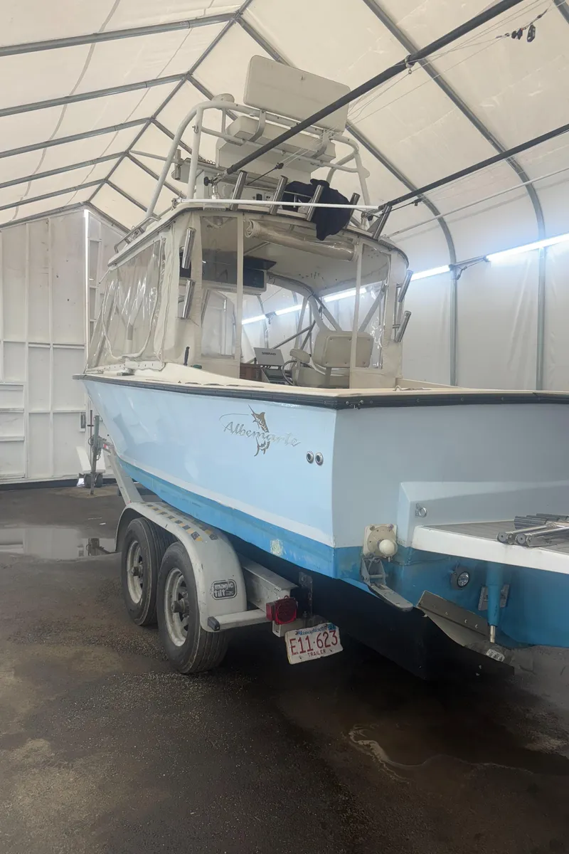 Slide: The Image of 1990 Albemarle 247 Express boat on trailer in covered storage. - 3