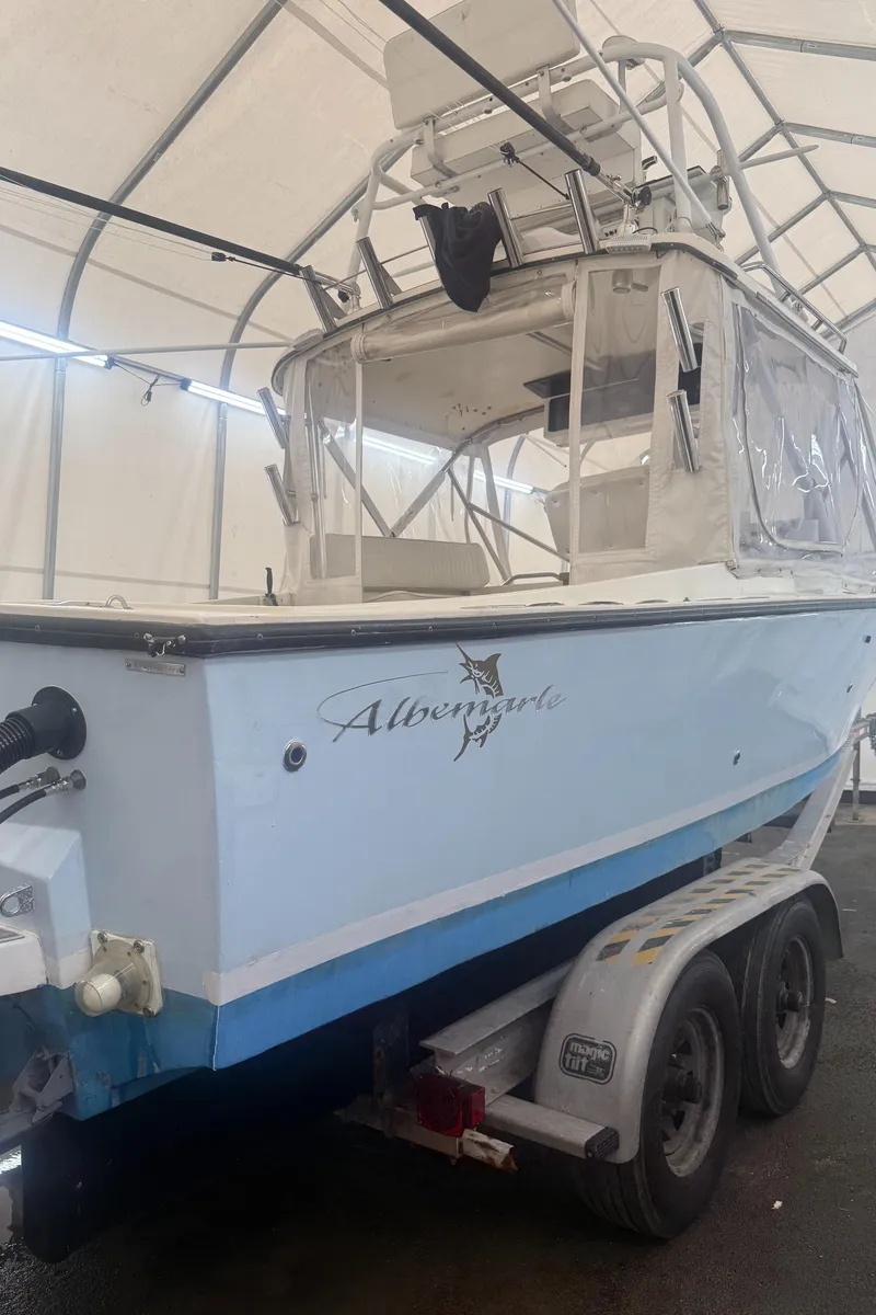 Slide: The Image of 1990 Albemarle 247 Express boat on trailer in covered storage. - 4