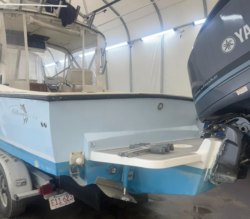 Slide: The Image of 1990 Albemarle 247 Express boat with Yamaha outboard motor in a covered storage area. - 5