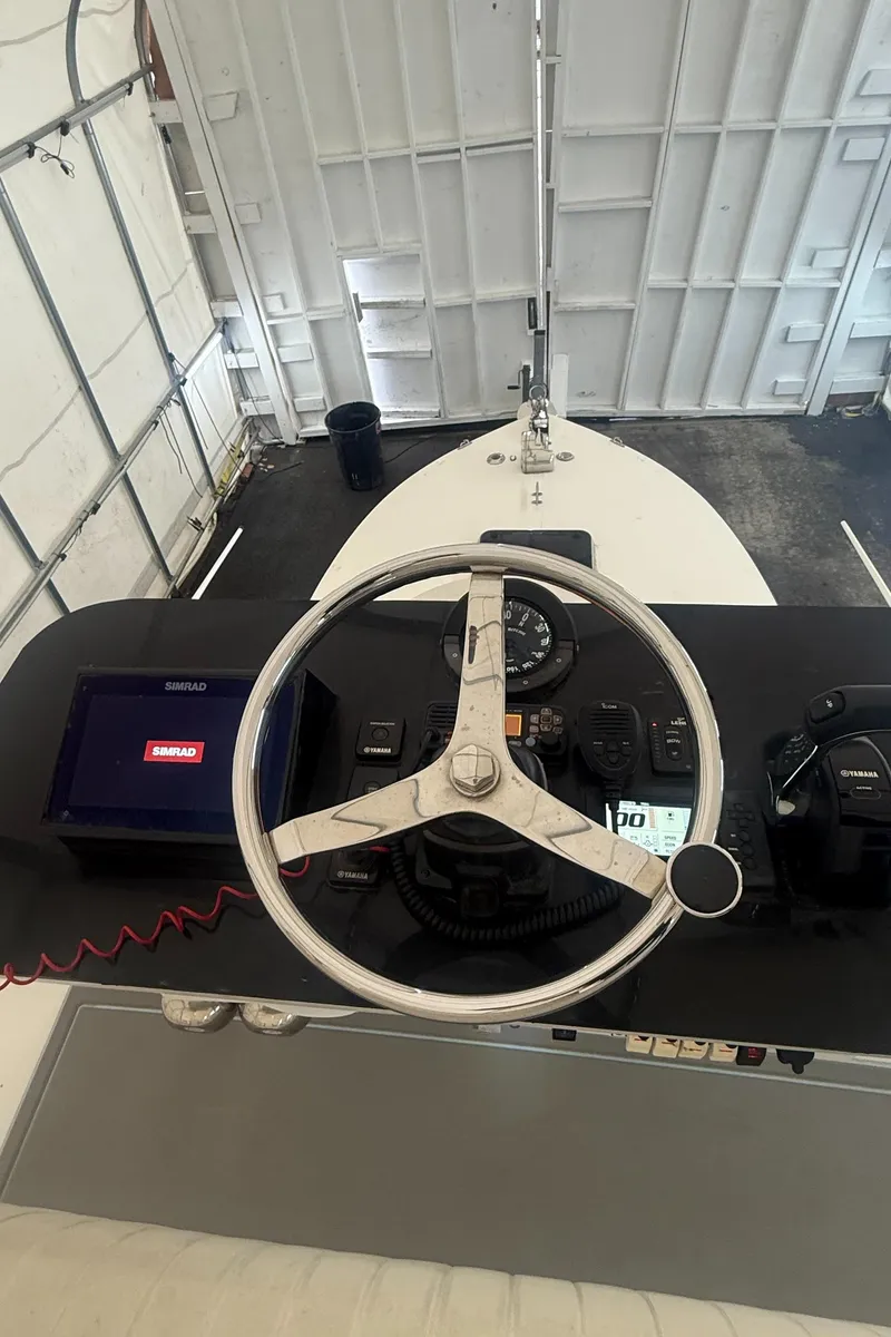 Slide: The Image of 1990 Albemarle 247 Express boat helm with steering wheel and navigation equipment. - 9