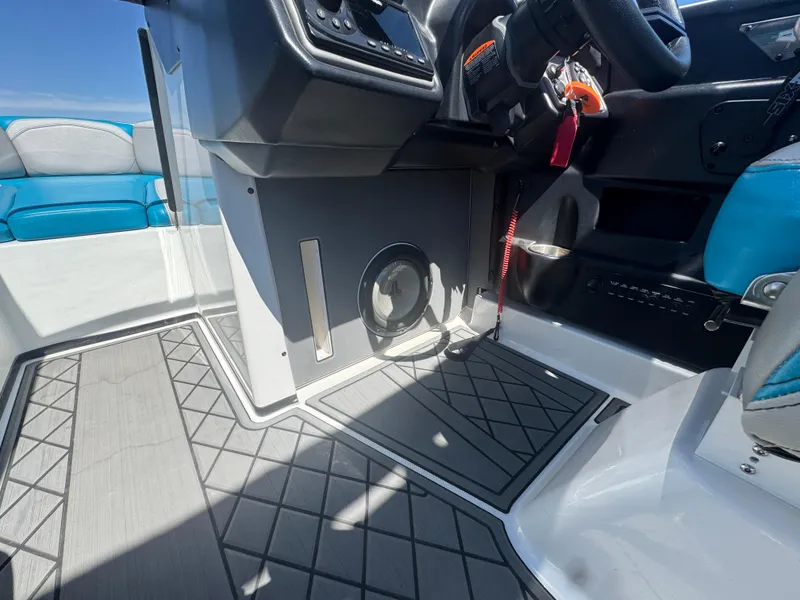 Slide: The Image of 2018 Axis T23 boat interior with steering wheel, speaker, and seating. - 15