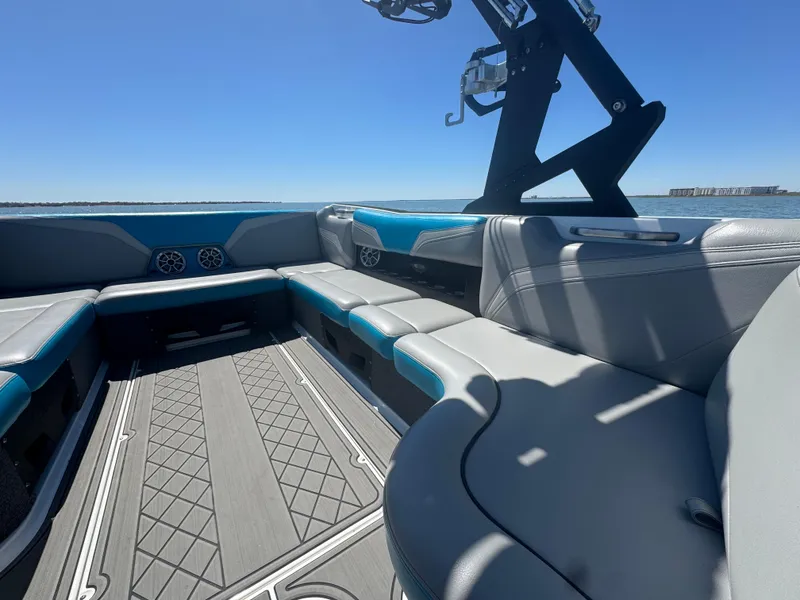 Slide: The Image of 2018 Axis T23 boat interior with gray and blue seating, open water view. - 16