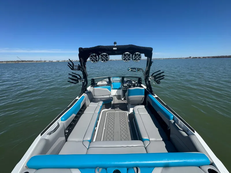 Slide: The Image of 2018 Axis T23 boat with blue and gray seating on a calm lake. - 18