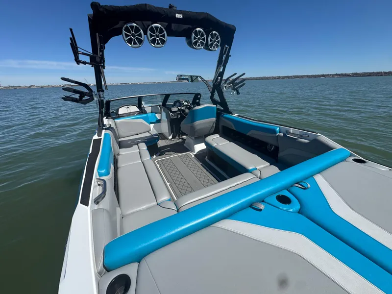 Slide: The Image of 2018 Axis T23 boat with blue and gray interior on a calm lake. - 19