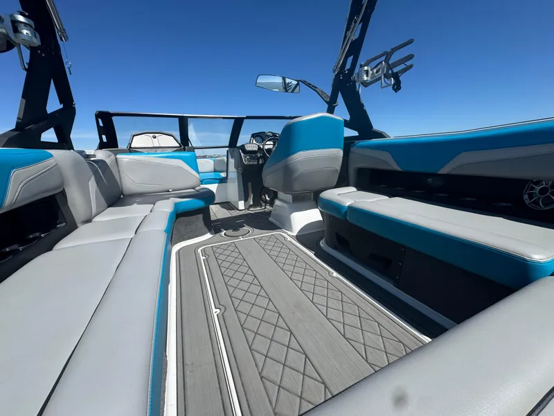 Slide: The Image of 2018 Axis T23 boat interior with blue and gray seating, open sky view. - 21
