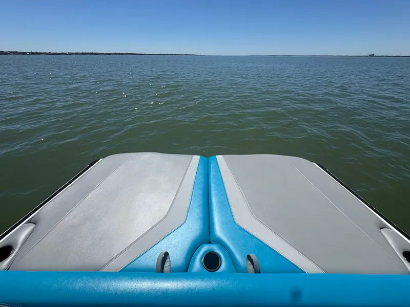 Slide: The Image of 2018 Axis T23 boat on calm water under clear blue sky. - 23