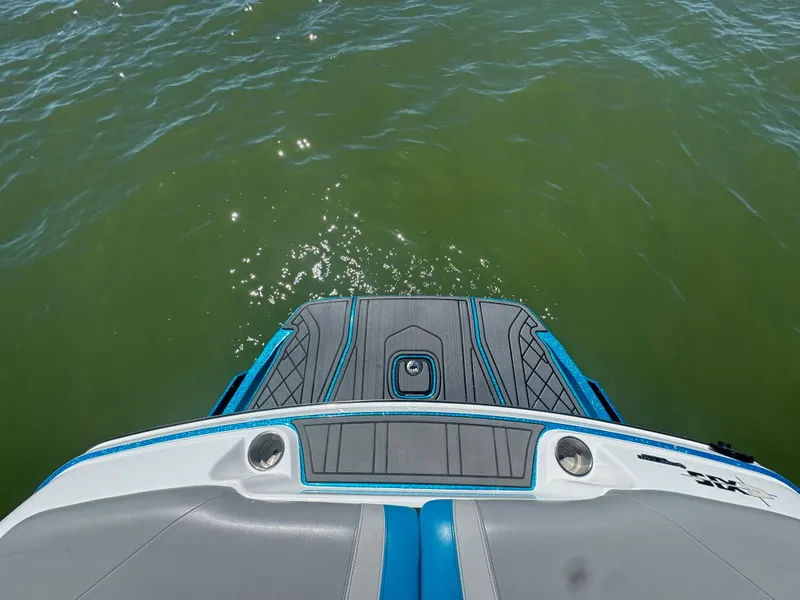 Slide: The Image of 2018 Axis T23 boat swim platform with blue accents on green water. - 24