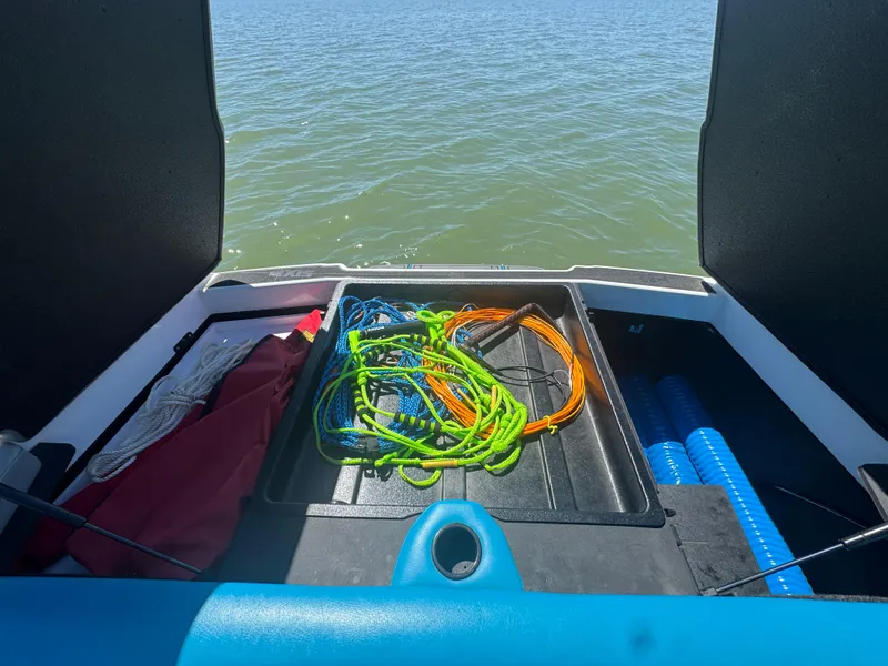 Slide: The Image of 2018 Axis T23 boat storage with colorful ropes and equipment by the water. - 25