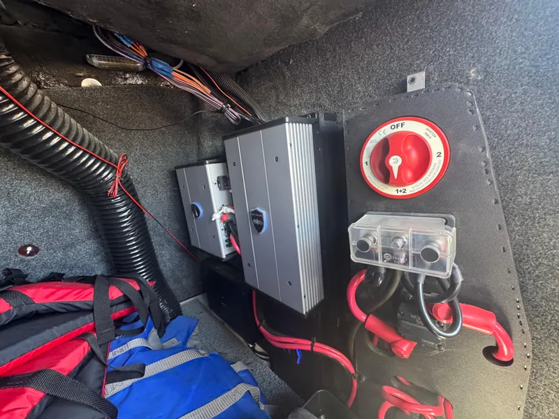 Slide: The Image of Electrical components inside a 2018 Axis T23 boat, featuring wiring and a battery switch. - 27
