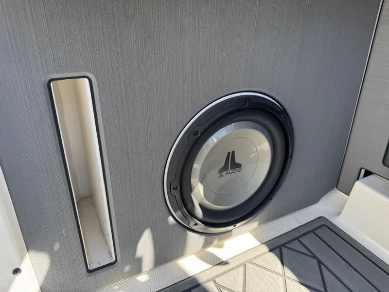 Slide: The Image of 2018 Axis T23 boat interior with JL Audio speaker and sleek design. - 28