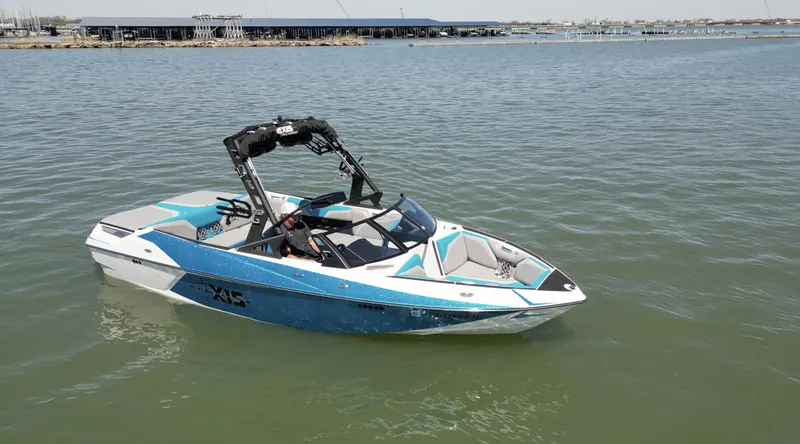 Slide: The Image of 2018 Axis T23 boat on calm water, featuring sleek design and vibrant blue accents. - 4