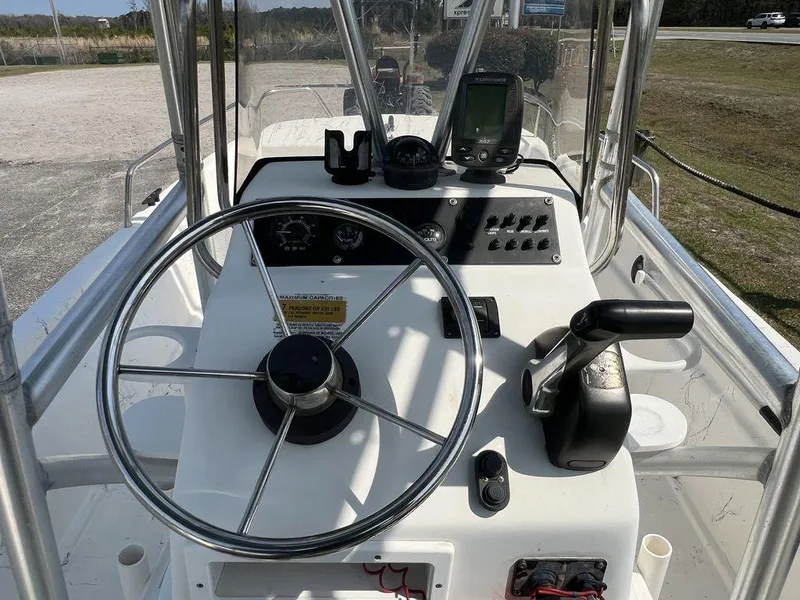 Slide: The Image of 2004 Sundance F17 boat console with steering wheel and navigation equipment. - 11
