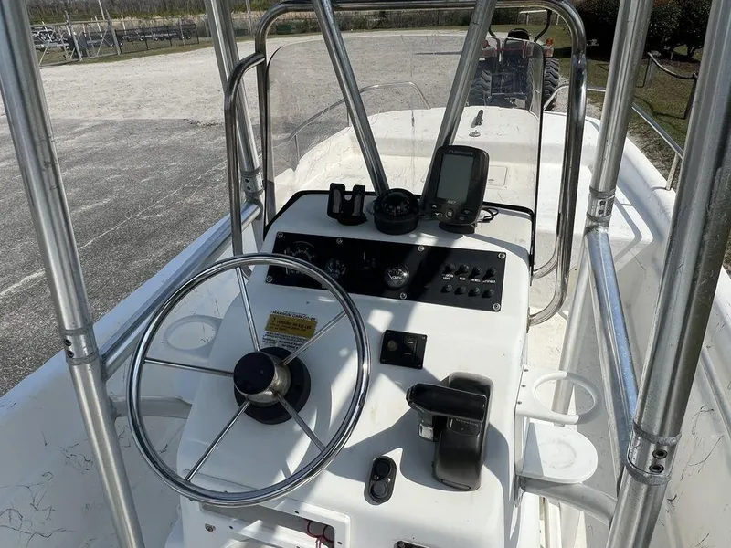 Slide: The Image of Center console of a 2004 Sundance F17 boat with steering wheel and navigation equipment. - 8