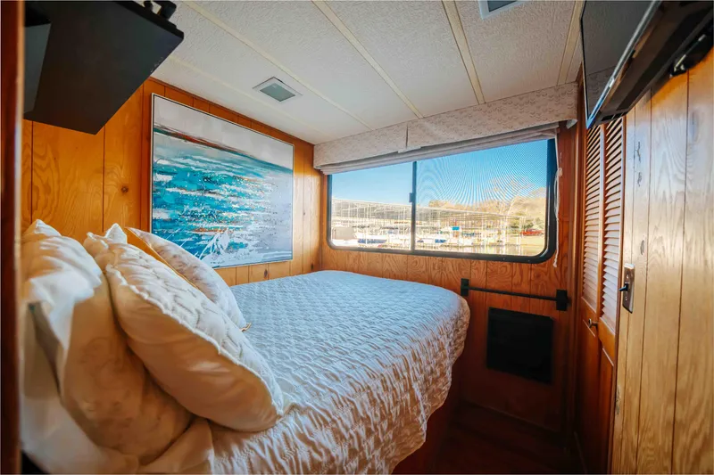 Slide: The Image of Cozy bedroom in 1989 Sumerset houseboat with wood paneling and scenic window view. - 13