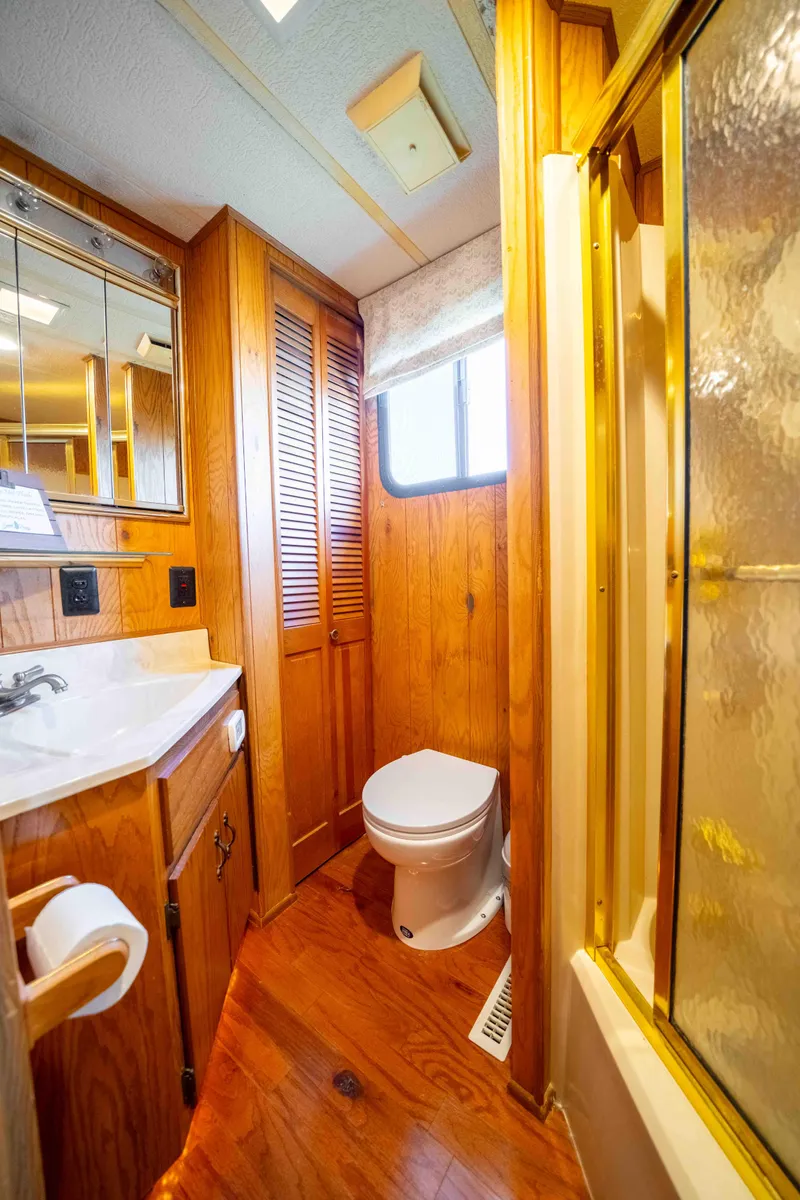 Slide: The Image of 1989 Sumerset houseboat bathroom with wood paneling, shower, and toilet. - 14
