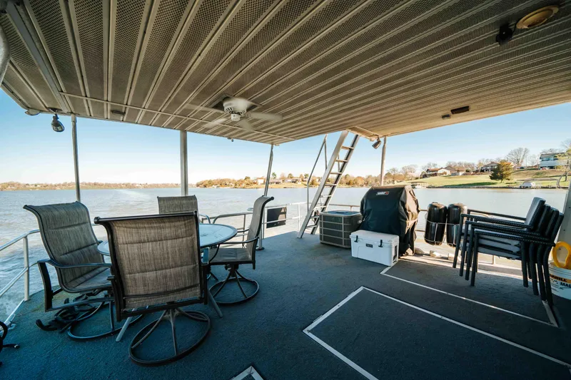 Slide: The Image of 1989 Sumerset houseboat deck with seating, grill, and lake view. - 20