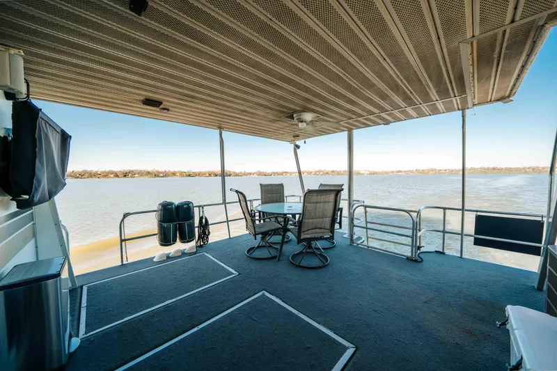Slide: The Image of 1989 Sumerset houseboat deck with seating, overlooking serene water view. - 21
