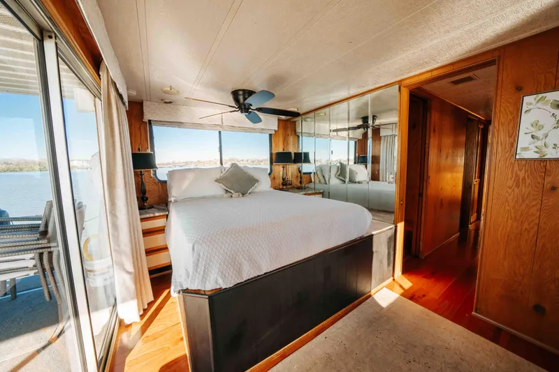 Slide: The Image of 1989 Sumerset houseboat bedroom with mirrored walls, large bed, and lake view. - 25