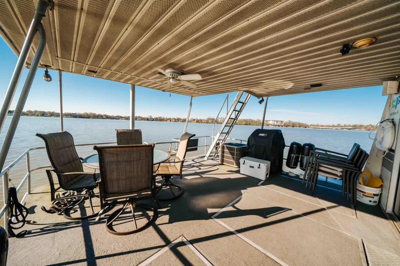 Slide: The Image of 1989 Sumerset houseboat deck with seating, grill, and lake view. - 27