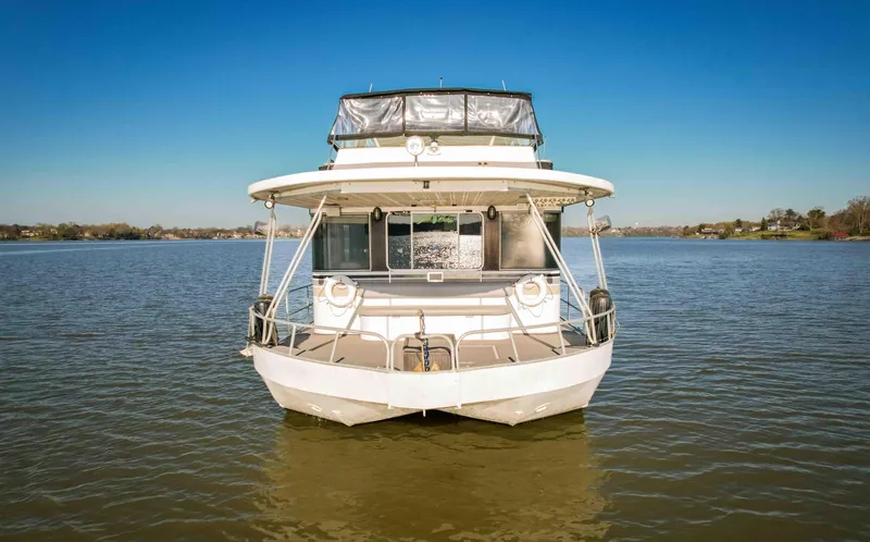 Slide: The Image of 1989 Sumerset houseboat on calm lake under clear blue sky. - 3