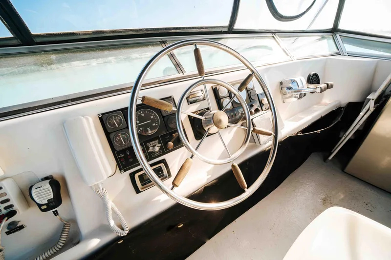 Slide: The Image of 1989 Sumerset houseboat helm with steering wheel and control panel. - 32