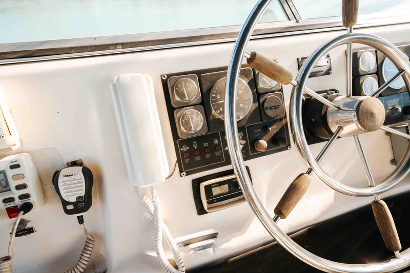 Slide: The Image of 1989 Sumerset houseboat helm with steering wheel and control panel. - 35
