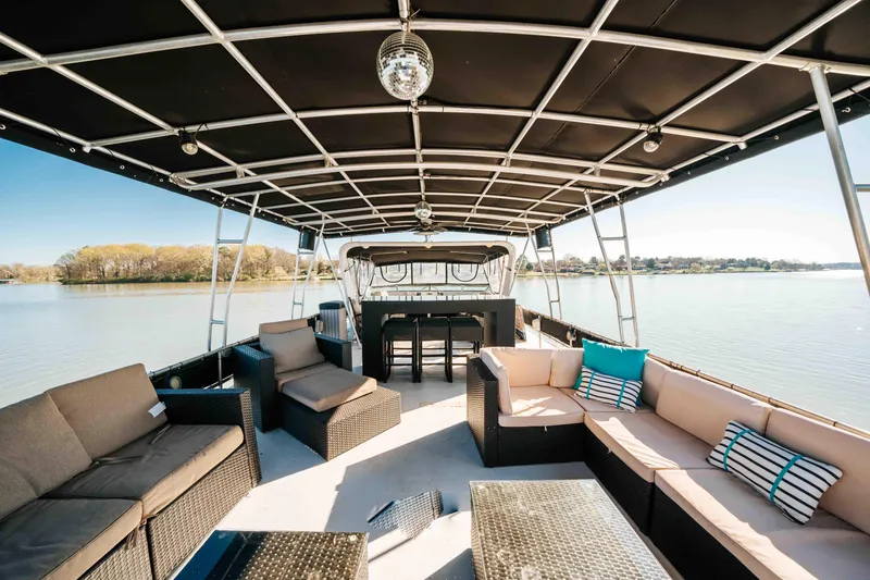 Slide: The Image of 1989 Sumerset houseboat interior with modern seating, spacious deck, and scenic lake view. - 38