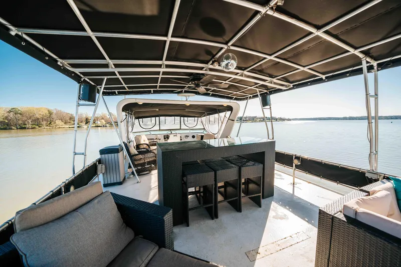 Slide: The Image of 1989 Sumerset houseboat with spacious deck, seating, and scenic lake view. - 39