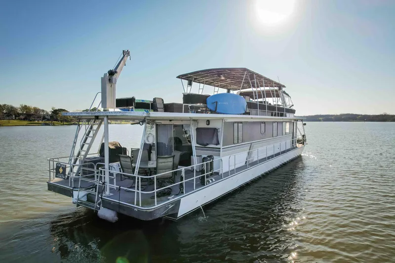 Slide: The Image of 1989 Sumerset houseboat on calm water under clear sky. - 5