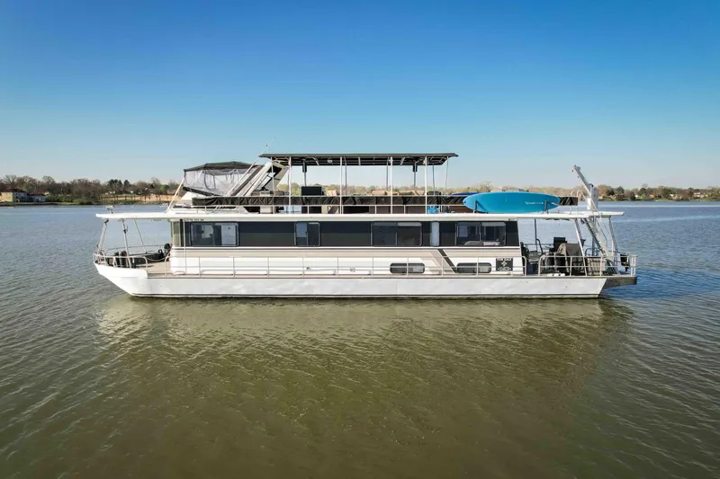 Slide: The Image of 1989 Sumerset houseboat on calm water under clear blue sky. - 7