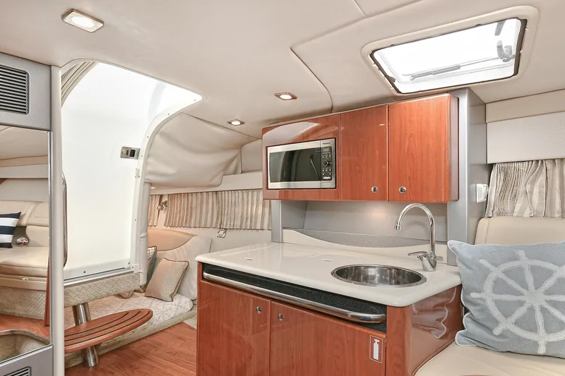 Slide: The Image of Interior of a 2010 Formula 350 SS boat with kitchenette and seating area. - 10