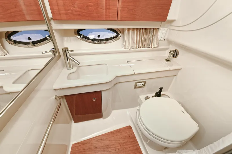 Slide: The Image of 2010 Formula 350 SS boat bathroom with sink, toilet, and porthole window. - 11