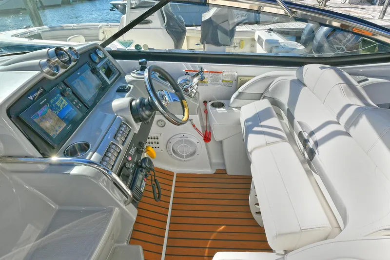 Slide: The Image of 2010 Formula 350 SS boat interior with modern dashboard and white seating. - 19