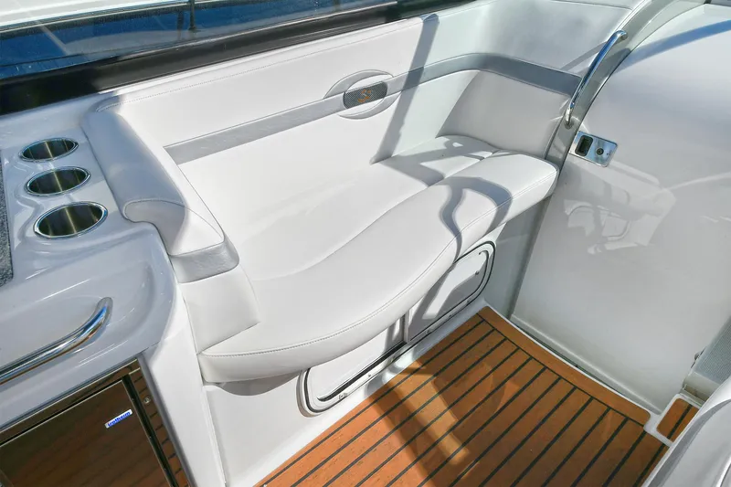 Slide: The Image of 2010 Formula 350 SS boat interior with white seating and wood flooring. - 20