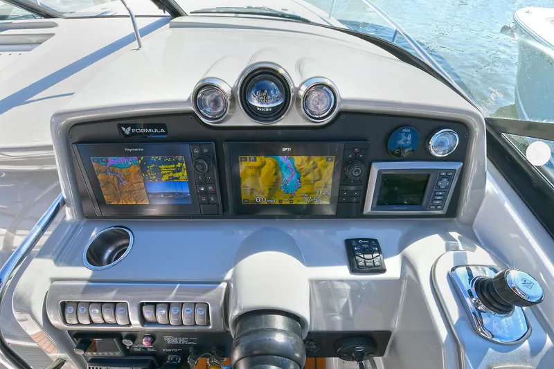 Slide: The Image of Dashboard of a 2010 Formula 350 SS boat with navigation screens and controls. - 23